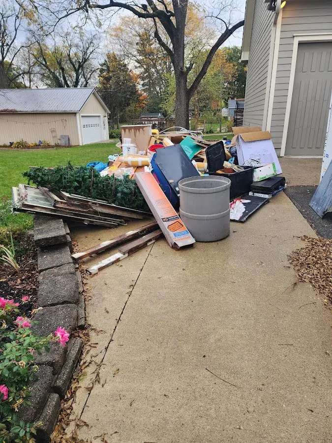 Dumpster being loaded with debris for Estate Cleanout Dumpster Rental in Berlin
